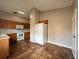 Kitchen with wood cabinets, white appliances, and tile flooring; bright and functional at 324 Anchovie Ct, Kissimmee, FL 34759