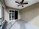 View of screened patio featuring ceiling fan and sliding door into home at 324 Anchovie Ct, Kissimmee, FL 34759