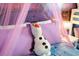 Close up of a comfy bed decorated with purple pillows and featuring a themed plush doll at 3432 Lilac Way, Davenport, FL 33897