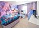 This bedroom features a queen bed, bunkbeds and a TV, all decorated in a cute winter theme at 3432 Lilac Way, Davenport, FL 33897