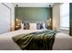 Elegant bedroom featuring a plush bed, decorative pillows, and stylish pendant lighting at 3432 Lilac Way, Davenport, FL 33897
