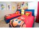 This themed bedroom features two twin beds with colorful decor and playful wall art at 3432 Lilac Way, Davenport, FL 33897