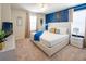 Stylish bedroom with a king bed, modern decor, and a bright blue accent wall at 3432 Lilac Way, Davenport, FL 33897
