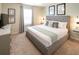 This elegant bedroom features a king-sized bed, a TV, and neutral decor, perfect for relaxation at 3432 Lilac Way, Davenport, FL 33897