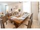 Elegant dining room with a large wooden table, seating for eight, and stylish decor throughout at 3432 Lilac Way, Davenport, FL 33897