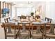 Bright dining room featuring a wooden table set for eight, adjacent to the open living area at 3432 Lilac Way, Davenport, FL 33897