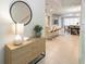 Inviting entryway featuring a stylish console table and decor, leading to the open-concept living spaces at 3432 Lilac Way, Davenport, FL 33897