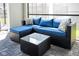 A comfortable blue cushioned outdoor sectional with throw pillows and a glass table at 3432 Lilac Way, Davenport, FL 33897