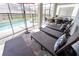 A screened-in pool area with lounge chairs and an outdoor dining set offers a luxurious retreat at 3432 Lilac Way, Davenport, FL 33897