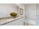 Bright bathroom featuring a double sink vanity with granite countertop and a shower at 3609 Salvia Ct, Tavares, FL 32778