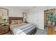 Comfortable bedroom with a decorative bed, side tables, and a view to an ensuite bathroom at 3609 Salvia Ct, Tavares, FL 32778