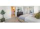 A modern bedroom features neutral tones, soft textures, and a stylish accent cabinet at 3609 Salvia Ct, Tavares, FL 32778