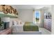 Comfortable bedroom featuring natural light, soft decor, and a decorative wall feature at 3609 Salvia Ct, Tavares, FL 32778