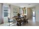 Bright dining room area with decorative lighting, large picture window, and wooden table at 3609 Salvia Ct, Tavares, FL 32778