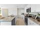 Gourmet kitchen with granite countertops, stainless steel appliances, and white cabinets at 3609 Salvia Ct, Tavares, FL 32778
