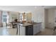 Open concept kitchen featuring granite counters, a kitchen island, and stainless steel appliances at 3609 Salvia Ct, Tavares, FL 32778