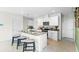 Modern kitchen with granite countertops, stainless steel appliances, white cabinetry, and island seating at 3609 Salvia Ct, Tavares, FL 32778