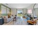 Bright living room with lots of natural light, neutral paint, modern decor, and an outdoor view at 3609 Salvia Ct, Tavares, FL 32778