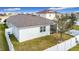 Aerial view of the home with a large backyard featuring a screened-in patio and a well-manicured lawn at 363 Buchannan Drive, Davenport, FL 33837