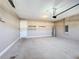 Spacious garage with concrete floor, shelving, water heater, and a door to the interior of the home at 363 Buchannan Drive, Davenport, FL 33837