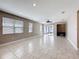 Large living room featuring tile floors, multiple windows for natural light, and a ceiling fan at 363 Buchannan Drive, Davenport, FL 33837