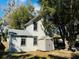 View of the home's backyard featuring a storage shed, trees, and partial backyard patio at 428 E Orange Ave, Eustis, FL 32726