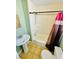 This is a quaint bathroom with a shower tub combo, pedestal sink and tile flooring at 428 E Orange Ave, Eustis, FL 32726