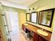 Bathroom features a double vanity with black framed mirrors and a stool at 428 E Orange Ave, Eustis, FL 32726