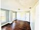 This bedroom has wood floors and neutral colored walls at 428 E Orange Ave, Eustis, FL 32726