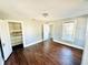 This bedroom has wood floors and neutral colored walls at 428 E Orange Ave, Eustis, FL 32726