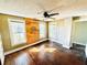 This bedroom has wood floors, three windows and custom wood paneling at 428 E Orange Ave, Eustis, FL 32726