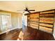 This bedroom has wood floors, one window and custom wood paneling at 428 E Orange Ave, Eustis, FL 32726