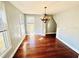 The dining room has hardwood flooring and a decorative chandelier at 428 E Orange Ave, Eustis, FL 32726