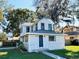 Charming two-story home with a beautifully landscaped yard and classic architectural details at 428 E Orange Ave, Eustis, FL 32726