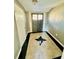 Foyer with striking tiled floor featuring a black starburst design and a vintage exterior door at 428 E Orange Ave, Eustis, FL 32726