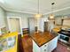 Bright kitchen featuring stainless steel appliances, an island and butcher block countertops at 428 E Orange Ave, Eustis, FL 32726