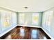 This living room has wood floors, three windows and neutral colored walls at 428 E Orange Ave, Eustis, FL 32726