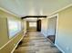 Living room showcasing wood floors, beadboard, window, and architectural detailing at 428 E Orange Ave, Eustis, FL 32726