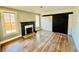Charming living room with fireplace, windows, hardwood floors, and barn door at 428 E Orange Ave, Eustis, FL 32726