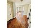Open-concept living area with hardwood floors and a connecting doorway at 428 E Orange Ave, Eustis, FL 32726
