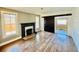 Spacious living room with a decorative fireplace and dark wood sliding doors at 428 E Orange Ave, Eustis, FL 32726