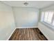 Cozy room with wood floors, wainscoting, and a window with natural light at 428 E Orange Ave, Eustis, FL 32726