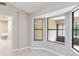 Bright sun room with light gray walls, neutral tile floors, and a wall of windows at 526 Thames Cir, Longwood, FL 32750