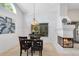 Cozy dining room with a fireplace, chandelier lighting, and backyard views at 702 Barrington Cir, Winter Springs, FL 32708