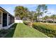 Well-manicured front yard showcasing lush green lawn, hedge landscaping, and a brick-columned entrance at 702 Barrington Cir, Winter Springs, FL 32708