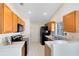 Functional kitchen with wooden cabinets, white countertops, and modern appliances at 702 Barrington Cir, Winter Springs, FL 32708