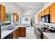 Well-lit kitchen area with stainless steel appliances and a breakfast bar open to the dining area at 702 Barrington Cir, Winter Springs, FL 32708