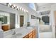 Large main bathroom with double sinks, a soaking tub, a separate shower, and mirrors at 702 Barrington Cir, Winter Springs, FL 32708