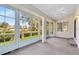 Bright sunroom with large windows offering views of the outdoors and a ceiling fan at 702 Barrington Cir, Winter Springs, FL 32708
