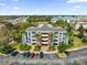 An aerial view of the condo building surrounded by palm trees and parking spaces at 7613 Cabana Ct # 402, Reunion, FL 34747